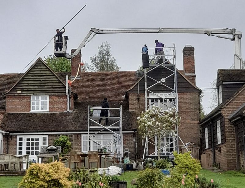 The Roof Moss Cleaners using cherry picker and scaffolding to clean roof safely and professionally in Waterbeach, Cambridgeshire